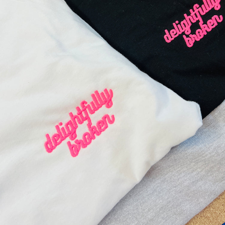 White Unisex Adults "Delightfully Broken" Embroidered T-Shirt